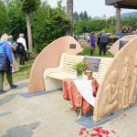 People visit at the Loved & Lost Memorial Bench on Sunday, June 12, 2022, at the Homer Public Library in Homer, Alaska, for a memorial for Anesha Duffy Murnane and the dedication of the bench. (Photo by Michael Armstrong/Homer News)