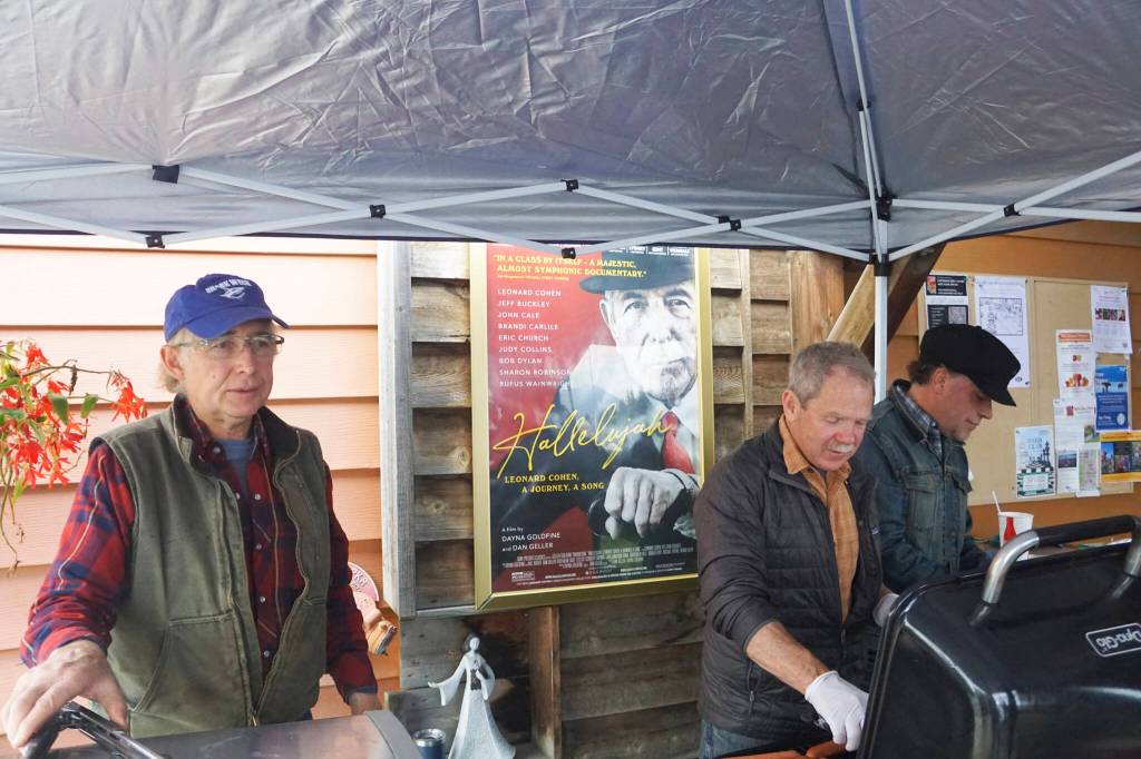 From left to right, Otto Kilcher, Carl Bice and Michael Walsh server reindeer sausages and hot dogs at the gala opening of the Homer Documentary Film Festival last Thursday, Sept. 22, 2022, at the Homer Theatre. (Photo by Michael Armstrong/Homer News)