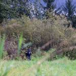 Clarise Larson / Juneau Empire
Officer Taylor Davis stands in a wooded area near what police described as an active crime scene. Davis and another officer asked for people to stay away from the area until further notice. No further details were offered from the officers as of 11 a.m.