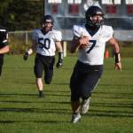 Homers Carter Tennison runs with the ball, pursued by Nikiskis Drake Brankel, on Friday, Sept. 23, 2022, at Nikiski High School in Nikiski, Alaska. (Jake Dye/Peninsula Clarion)