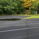 A crack splits a warped track at Nikiski Middle/High School on Monday, Sept. 19, 2022, in Nikiski, Alaska. The track is one of several projects in a bond package Kenai Peninsula voters will consider during the Oct. 4 municipal election next month. (Ashlyn OHara/Peninsula Clarion)