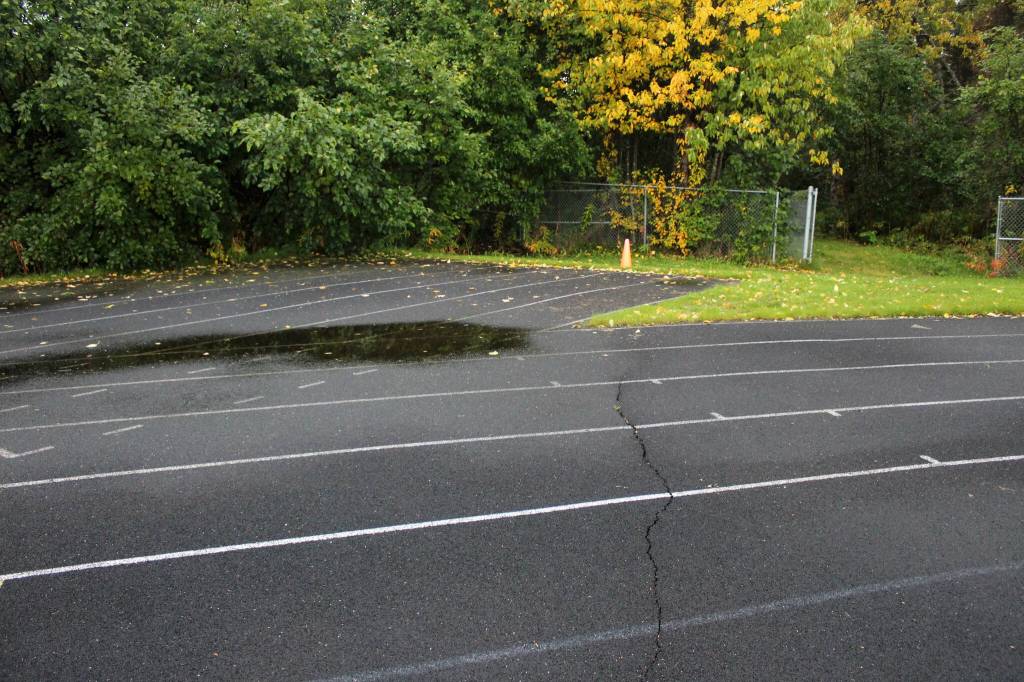 A crack splits a warped track at Nikiski Middle/High School on Monday, Sept. 19, 2022, in Nikiski, Alaska. The track is one of several projects in a bond package Kenai Peninsula voters will consider during the Oct. 4 municipal election next month. (Ashlyn OHara/Peninsula Clarion)