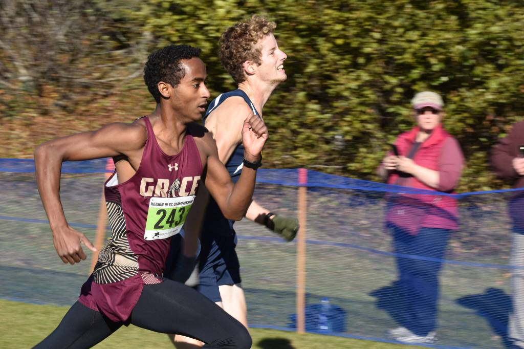 Grace Christians David Sliwinski and Homers Seamus McDonough both make their last push to the finish chute during the Region 3/Division II race on Saturday, Oct. 1, 2022, at Tsalteshi Trails just outside of Soldotna Alaska. (Jake Dye/Peninsula Clarion)