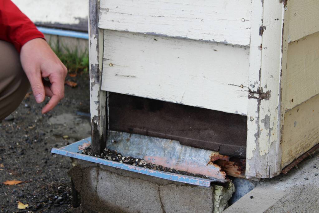 Soldotna Elementary School Principal Dr. Austin Stevenson points out corroded insulation outside of the school building on Friday, Sept. 30, 2022, in Soldotna, Alaska. (Ashlyn OHara/Peninsula Clarion)