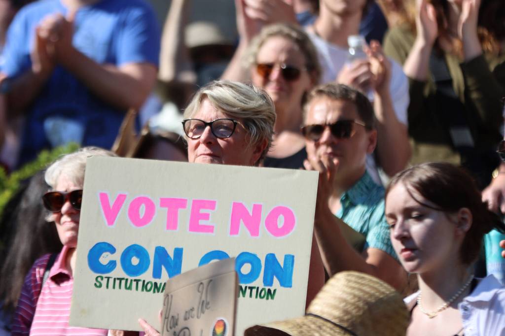 Former Democratic state Rep. Beth Kerttula holds up a sign reading Vot No Con Con, during a rally at the Dimond Courthouse Plaza in Juneau. (Ben Hohenstatt / Juneau Empire File)