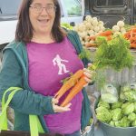 Homer resident Beth Carroll visits the Twitter Creek Farms booth at the Homer Farmers Market on Sunday. A few vendors are still selling there on Saturdays and Wednesdays. (Photo by Christina Whiting)