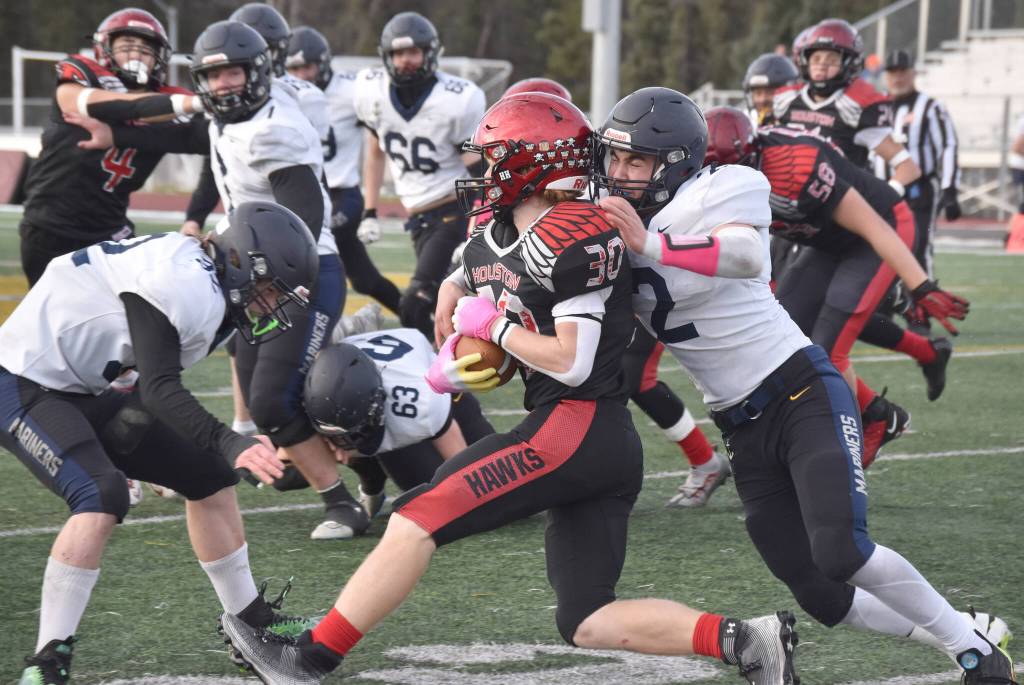 Houstons Noah Whitted is tackled by Homers Chris Martishev on Saturday, Oct. 15, 2022, in the Division III state championship game at Service High School in Anchorage, Alaska. (Photo by Jeff Helminiak/Peninsula Clarion)