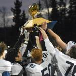 Homer hoists the Division III state championship trophy Saturday, Oct. 15, 2022, at Service High School in Anchorage, Alaska. (Photo by Jeff Helminiak/Peninsula Clarion)