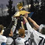 Homer hoists the Division III state championship trophy Saturday, Oct. 15, 2022, at Service High School in Anchorage, Alaska. (Photo by Jeff Helminiak/Peninsula Clarion)