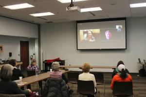 Candidates for Alaska State House District 6 Ginger Bryant, on screen, left, and Louie Flora, on screen, right, participate remotely in a forum held at the Soldotna Public Library on Monday, Oct. 24, 2022 in Soldotna, Alaska. (Ashlyn OHara/Peninsula Clarion)