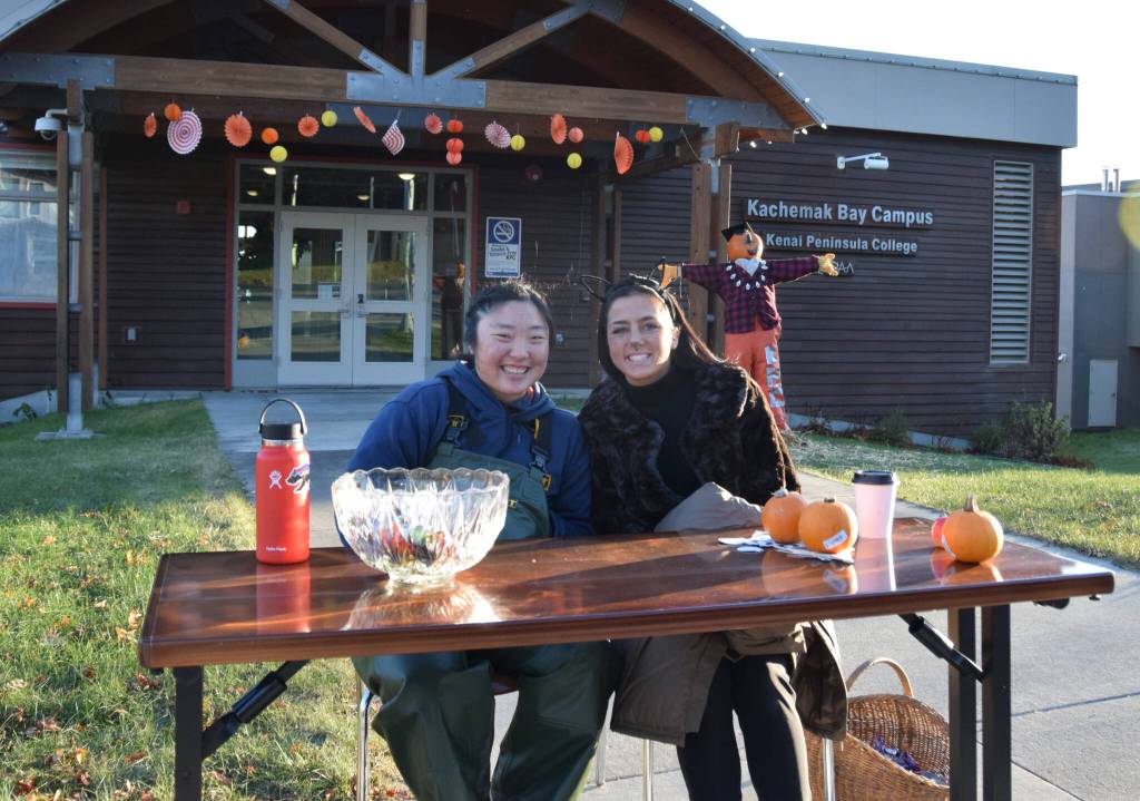 Alyssum Veldstra and Debbie Weisser, students at the University of Alaska Kachemak Bay Campus, pass out candy during the Homer Chamber of Commerces first annual Pioneer Avenue Trick-or-Treat event on Monday, Oct. 31 in Homer, Alaska. (Photo by Charlie Menke / Homer News)