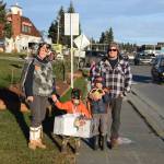 Kids show of their candy during the Homer Chamber of Commerces first annual Pioneer Avenue Trick-or-Treat event on Monday, Oct. 31 in Homer, Alaska. (Photo by Charlie Menke / Homer News)