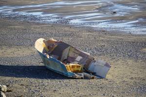 The hull of a wrecked boat lies on the Homer Spit beach on Friday afternoon, Oct. 21, 2022, in Homer, Alaska. (Photo by Michael Armstrong/Homer News)