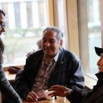 Raymond Wilson, 89, right, tells U.S. Rep. Mary Peltola during a meet-and-greet Tuesday at Coppa he plans to perform a ceremony invoking the spirit of a Chilkat headdress and robe on display at the Alaska State Museum, and for her to imagine you have the Chilkat blanket around you when they start throwing mud and it will protect you. (Mark Sabbatini / Juneau Empire)