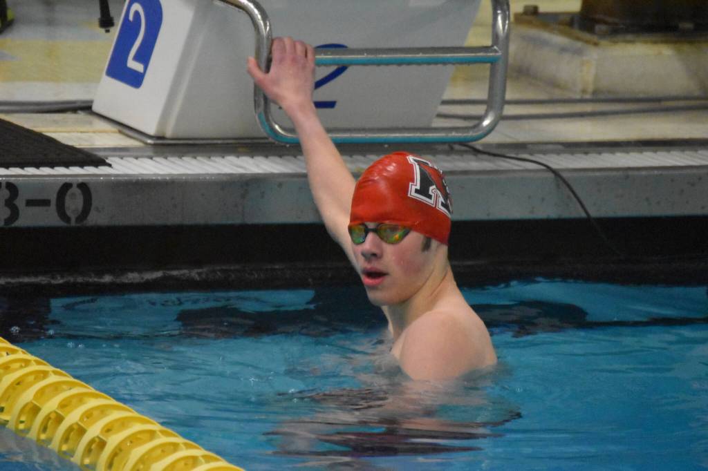 Samuel Anderson, of Kenai, looks to his coach after finishing the 200-yard freestyle during finals at the ASAA State Swim & Dive Championships on Saturday, Nov. 5, 2022, at Bartlett High School in Anchorage, Alaska. (Jake Dye/Peninsula Clarion)