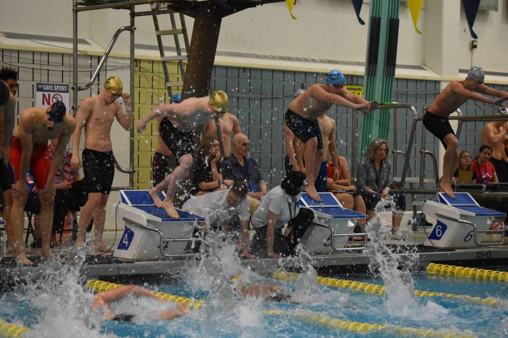 Jackson Bird, of Seward, performs a relay start over teammate Nickolas Ambrosiani during the 200-yard freestyle relay during finals at the ASAA State Swim & Dive Championships on Saturday, Nov. 5, 2022, at Bartlett High School in Anchorage, Alaska. (Jake Dye/Peninsula Clarion)