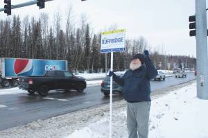 Ashlyn OHara/Peninsula Clarion
Larry Opperman waves a sign in support of Alaska House candidate Justin Ruffridge at the intersection of the Kenai Spur and Sterling highways on Tuesday in Soldotna.