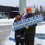 From left, Jamie, Brinna and Jesse Bjorkman wave signs supporting Jesse Bjorkman's bid for Alaska State Senate at the intersection of the Kenai Spur and Sterling highways on Tuesday, Nov. 8, 2022 in Soldotna, Alaska. (Ashlyn O'Hara/Peninsula Clarion)