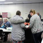 Poll worker Harmony Bolden (right) helps a voter cast their ballot at the Soldotna Regional Sports Complex on Tuesday, Nov. 8, 2022 in Soldotna, Alaska. (Ashlyn O'Hara/Peninsula Clarion)