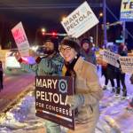 U.S. Rep. Mary Peltola waves a sign during the morning rush hour in Anchorage, Alaska, on Tuesday Nov. 8, 2022. Peltola, who became the first Alaska Native elected to Congress when she won a special election earlier this year, faces Republicans Sarah Palin and Nick Begich and Libertarian Chris Bye in the general election. (AP Photo/Mark Thiessen)