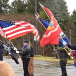 Homer veterans bear flags for Veterans Day on Friday, Nov. 11 at Alaska Maritime National Wildlife Refuge Visitor Center in Homer. (Photo by Charlie Menke / Homer News)