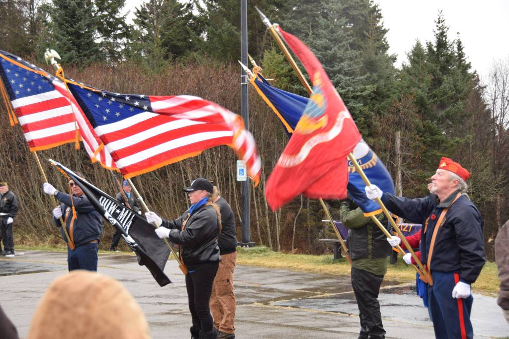 Homer veterans bear flags for Veterans Day on Friday, Nov. 11 at Alaska Maritime National Wildlife Refuge Visitor Center in Homer. (Photo by Charlie Menke / Homer News)