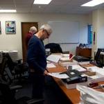 Steve Lewis, foreground, and Stephen Sorensen from the Alaska State Review Board scan ballots from precincts where they were hand counted at the Division of Elections office Tuesday. The hand counts were for first-choice votes only, while the scans will be used for ranked choice tallies for any races where a candidate does not have a first-choice majority. (Mark Sabbatini / Juneau Empire)