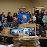 David Lewis speaks at at the meeting of the Library Advisory Board on Nov. 15, 2022, in the Cowles Council Chambers at Homer City Hall in Homer, Alaska. A pile of books a citizens group has LGBQT+ content that it has asked to be removed from the childrens section of the Homer Public Library lies on the table in the foreground. (Photo by Michael Armstrong/Homer News)