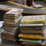 Some of the Homer Public Library books a citizens group has asked be removed from the children's section lie on a table at the meeting of the Library Advisory Board on Nov. 15, 2022, in the Cowles Council Chambers at Homer City Hall in Homer, Alaska. (Photo by Michael Armstrong/Homer News)