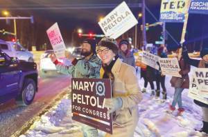 U.S. Rep. Mary Peltola waves a sign during the morning rush hour in Anchorage, Alaska, on Tuesday Nov. 8, 2022. Peltola, who became the first Alaska Native elected to Congress when she won a special election earlier this year, faces Republicans Sarah Palin and Nick Begich and Libertarian Chris Bye in the general election. (AP Photo/Mark Thiessen)