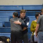 Liam Babitt hugs his coach after being honored during Senior Night at a duel wrestling meet on Tuesday, Nov. 22, 2022, at Soldotna High School in Soldotna, Alaska. (Jake Dye/Peninsula Clarion)