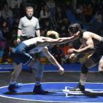 Soldotnas Edger Land swings at Nikiskis Jakeup Martin during a duel wrestling meet on Tuesday, Nov. 22, 2022, at Soldotna High School in Soldotna, Alaska. (Jake Dye/Peninsula Clarion)