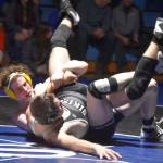 Soldotnas Hunter Richardson holds Nikiskis Tim Goodnight during a duel wrestling meet on Tuesday, Nov. 22, 2022, at Soldotna High School in Soldotna, Alaska. (Jake Dye/Peninsula Clarion)