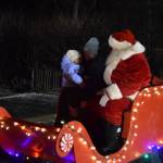Photo by Charlie Menke / Homer News
Santa welcomes a young one on Thursday, Dec. 1, at the Homer Chamber of Commerce in Homer.