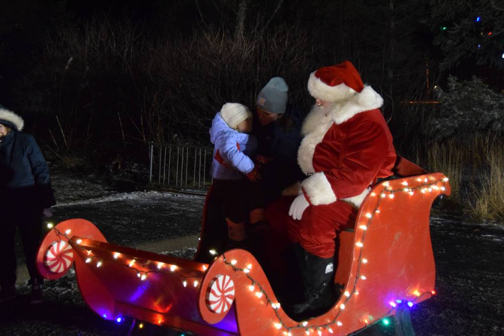 Photo by Charlie Menke / Homer News
Santa welcomes a young one on Thursday, Dec. 1, at the Homer Chamber of Commerce in Homer.