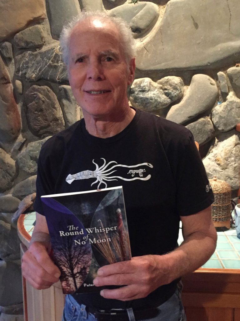 Peter Kaufmann holds a copy of his book of poetry, "The Round Whisper of No Moon." (Photo provided)