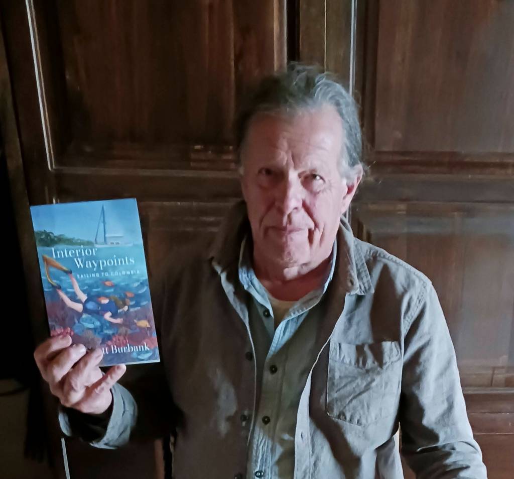 Scott Burbank hold a copy of his adventure book, Interior Waypoints. (Photo provided)