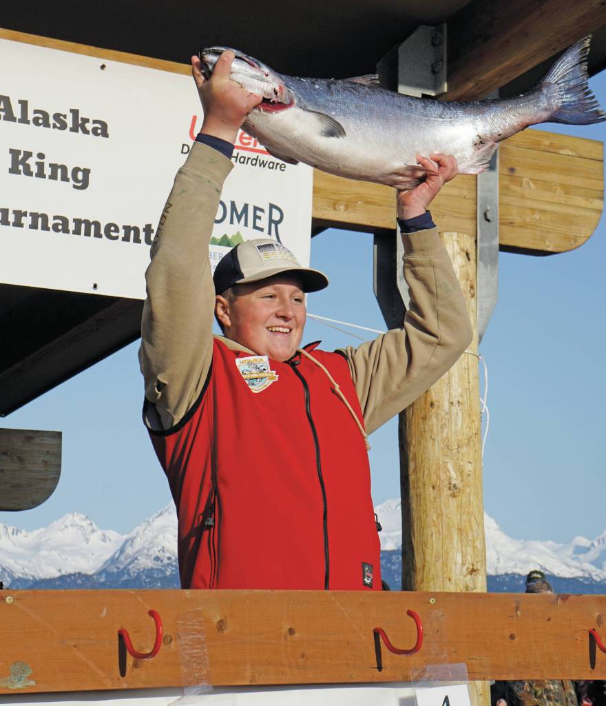 Weston Marley holds up the 27.38-pound winter king salmon he caught to win the 28th annual Homer Winter King Salmon Tourament on Sunday, April 10 in Kachemak Bay. Marley, 15, fished on the Fly Dough with his father, Jay Marley, and brother, Andrew Marley. Its the second year a Marley boy won the tournament, with Andrew taking first place for a 25.62-pound king in 2022. (Photo by Michael Armstrong/Homer News)