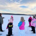 Photo by Catie Shelden 
Snowshoers talk with Ranger Leah Eskelin during a December snowshoe walk at the Kenai National Wildlife Refuge.