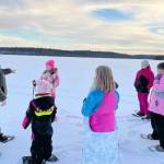 Snowshoers talk with Ranger Leah Eskelin during a December snowshoe walk at the Kenai National Wildlife Refuge.  (Photo by Catie Shelden)