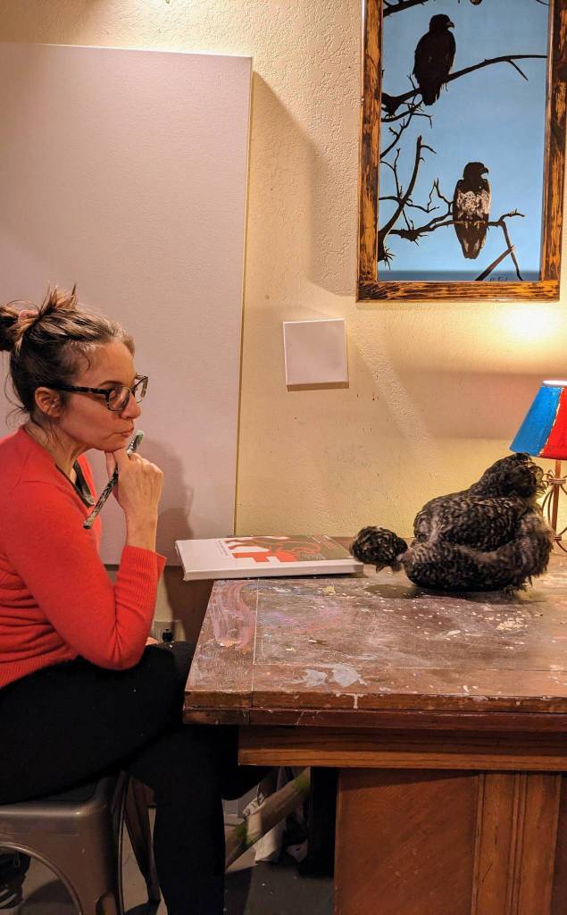 Homer artist Julianne Tomich in her home studio with her chicken Pearl. (Photo provided by Julianne Tomich)