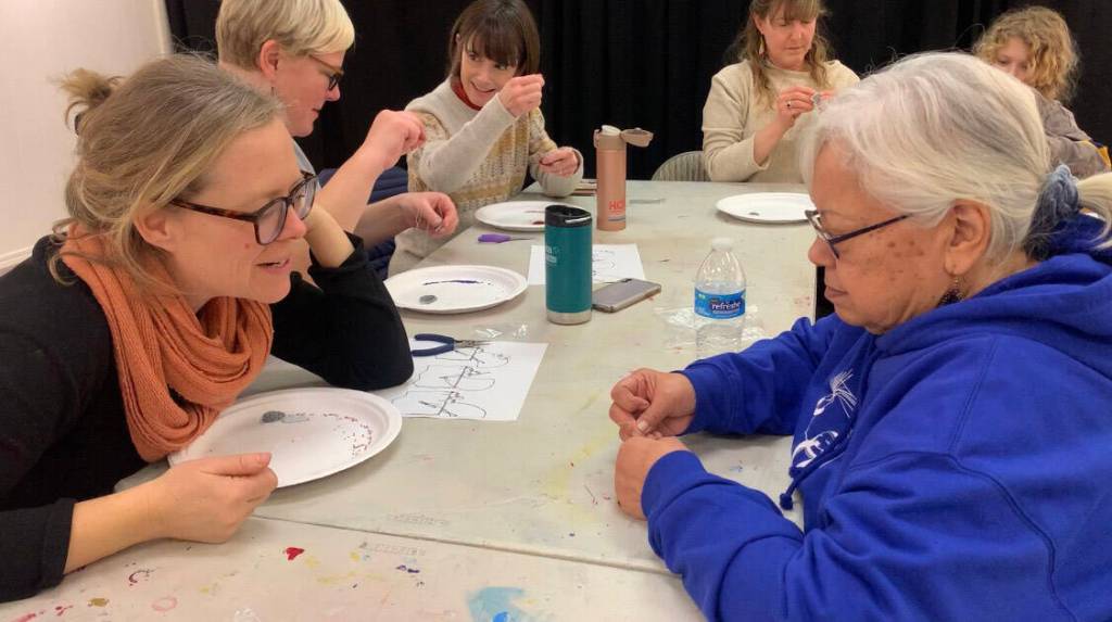 Alutiiq_Inupiat Artist June Pardue (right) demonstrates beading salmon skin leather to participant Amanda Campbell (left) during a recent workshop at HCOA. (Photo by Christina Whiting/Homer News)