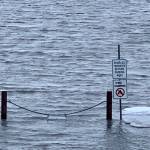 High tide washes into a parking area along the Homer Spit Road, Jan. 22, 2023, in Homer, Alaska. (Photo by Christina Whiting)