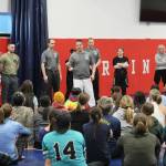 Homer Police Department Lt. Ryan Browning (center) provides opening remarks at a Toss A Cop event at the All American Training Center on Saturday, Jan. 21, 2023, in Soldotna, Alaska. (Ashlyn OHara/Peninsula Clarion)