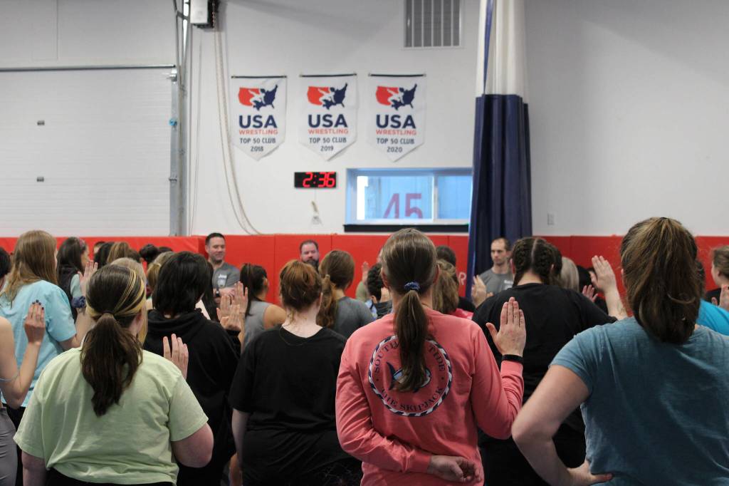 Women take an oath at a Toss A Cop event at the All American Training Center on Saturday, Jan. 21, 2023, in Soldotna, Alaska. (Ashlyn OHara/Peninsula Clarion)