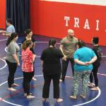 Soldotna Police Chief Gene Meek leads attendees in exercises during a Toss A Cop event at the All American Training Center on Saturday, Jan. 21, 2023, in Soldotna, Alaska. (Ashlyn OHara/Peninsula Clarion)