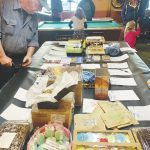 A community member checks out items in the silent auction, part of a benefit held last Saturday at the Down East Saloon for the Pariyar Family that raised more than $5,000. (Photo by Christina Whiting/Homer News)