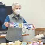 Community member Alice Porter shows an accordian book she made to participants in her class at the library last Saturday. (Photo by Christina Whiting/Homer News)