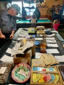 A community member checks out items in the silent auction, part of a benefit held last Saturday at the Down East Saloon for the Pariyar Family that raised more than $5,000. (Photo by Christina Whiting/Homer News)