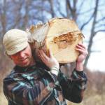 Photo by Brad Hillwig/courtesy
Homer woodworker Tony Perelli hauls a piece of wood that he will turn into bowls, plates, or spoons in this undated photo.